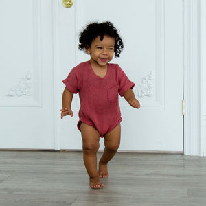 Toddler boy walking in linen romper